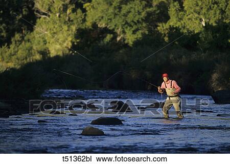 Stock Image - Man fly fishing. Fotosearch