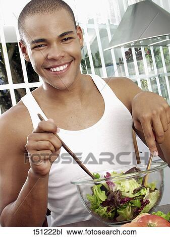 Man in the kitchen preparing salad View Large Photo Image Stock Image - Man in the kitchen preparing salad. Fotosearch