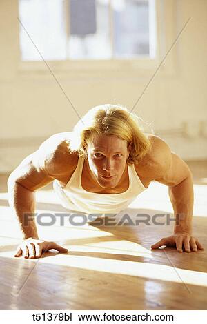 Man performing pushups in gym View Large Photo Image Stock Image - Man performing pushups in gym. Fotosearch