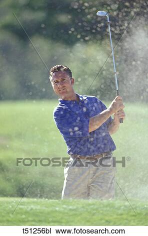 Man playing golf from sand trap View Large Photo Image Stock Image - Man playing golf from sand trap. Fotosearch