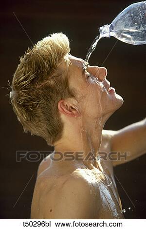 Stock Image - Man pouring water on his face. Fotosearch