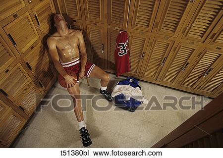 Man relaxing in the locker room after basketball work out View Large Photo Image Stock Image - Man relaxing in the locker room after basketball work out. Fotosearch
