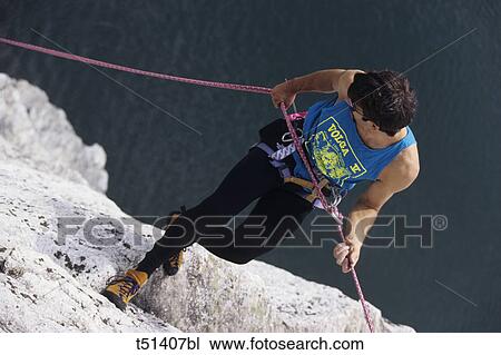 Man rock climbing View Large Photo Image Stock Image - Man rock climbing. Fotosearch