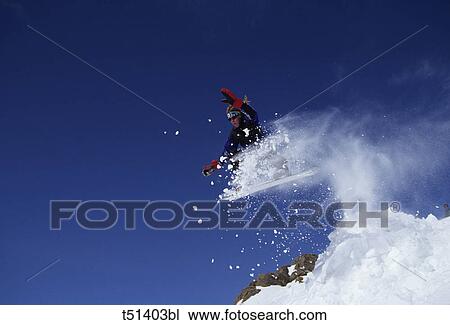 Man snowboarding down mountainside View Large Photo Image Stock Image - Man snowboarding down mountainside. Fotosearch