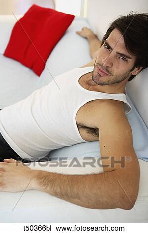 Man's portrait sitting on sofa View Large Photo Image Stock Image - Man's portrait sitting on sofa. Fotosearch