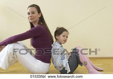 mother and daughter sitting back to back on floor little girl looking sulky View Large Photo Image Stock Image - mother and daughter sitting back to back on floor little girl looking sulky. Fotosearch