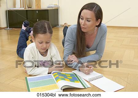 mother and little daughter lying on floor doing homework together View Large Photo Image Stock Image - mother and little daughter lying on floor doing homework together. Fotosearch