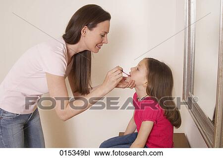 mother applying some lipgloss on her daughter´s mouth View Large Photo Image Stock Image - mother applying some lipgloss on her daughter´s mouth. Fotosearch