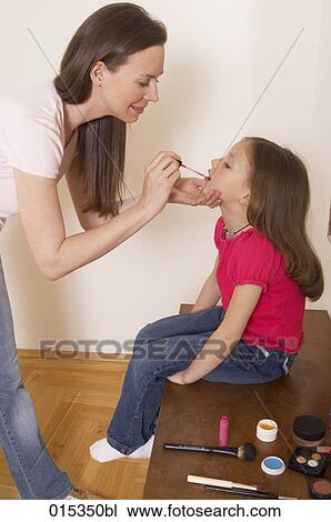 mother applying some lipgloss on her daughter´s mouth View Large Photo Image Stock Image - mother applying some lipgloss on her daughter´s mouth. Fotosearch