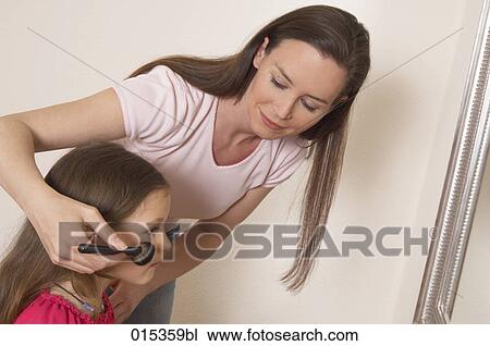 mother applying some rouge on her daughter´s cheek View Large Photo Image Stock Image - mother applying some rouge on her daughter´s cheek. Fotosearch