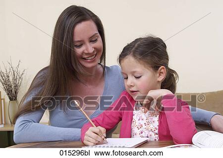 mother helping her young daughter with homework View Large Photo Image Stock Image - mother helping her young daughter with homework. Fotosearch