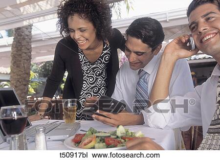 People working while having lunch View Large Photo Image Stock Image - People working while having lunch. Fotosearch