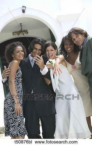 Portrait of bride and groom with friends View Large Photo Image Stock Image - Portrait of bride and groom with friends. Fotosearch