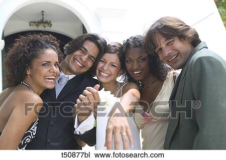 Portrait of bride and groom with friends View Large Photo Image Stock Image - Portrait of bride and groom with friends. Fotosearch