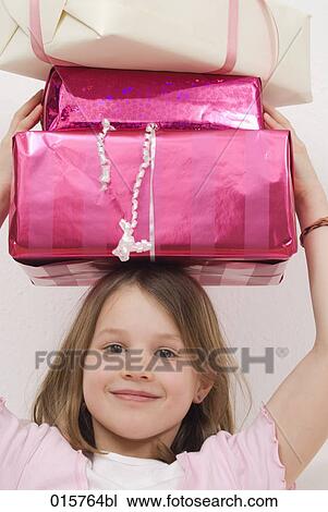 portrait of girl carrying presents on her head View Large Photo Image Stock Image - portrait of girl carrying presents on her head. Fotosearch
