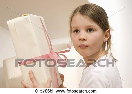 portrait of girl holding present View Large Photo Image Stock Image - portrait of girl holding present. Fotosearch