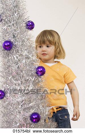 portrait of little girl decorating christmas tree View Large Photo Image Stock Image - portrait of little girl decorating christmas tree. Fotosearch
