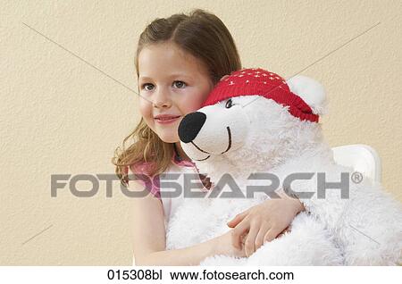 portrait of little girl holding cuddly toy in shape of polar bear View Large Photo Image Stock Image - portrait of little girl holding cuddly toy in shape of polar bear. Fotosearch