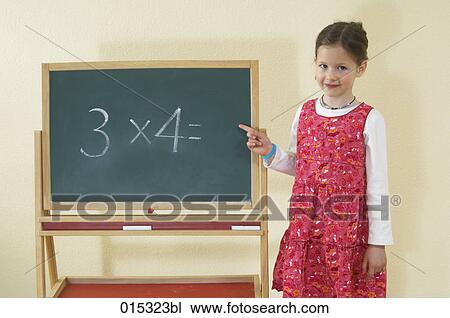 portrait of little girl pointing at blackboard with calculating problem View Large Photo Image Stock Image - portrait of little girl pointing at blackboard with calculating problem. Fotosearch