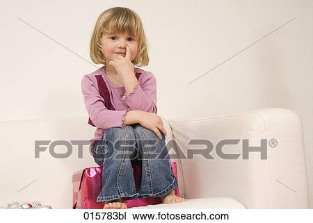 portrait of little girl sitting on present on sofa View Large Photo Image Stock Image - portrait of little girl sitting on present on sofa. Fotosearch
