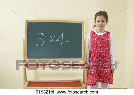 portrait of little girl standing at blackboard with calculating problem View Large Photo Image Stock Image - portrait of little girl standing at blackboard with calculating problem. Fotosearch