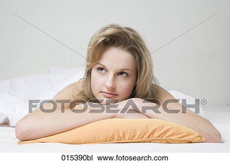 portrait of melancholic young woman lying on bed View Large Photo Image Stock Image - portrait of melancholic young woman lying on bed. Fotosearch