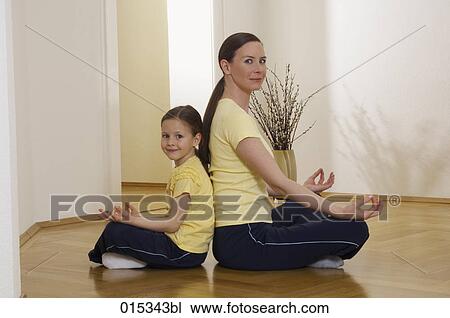 portrait of mother and daughter sitting back to back on floor in lotus position View Large Photo Image Stock Image - portrait of mother and daughter sitting back to back on floor in lotus position. Fotosearch