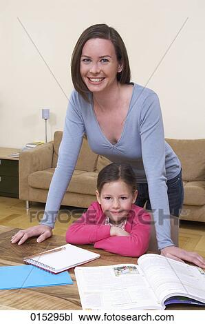 portrait of mother and young daughter at table doing homework View Large Photo Image Stock Image - portrait of mother and young daughter at table doing homework. Fotosearch