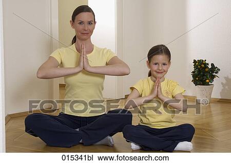 portrait of mother and young daughter doing yoga together View Large Photo Image Stock Image - portrait of mother and young daughter doing yoga together. Fotosearch