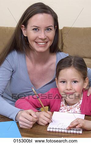 portrait of mother helping her young daughter with homework View Large Photo Image Stock Image - portrait of mother helping her young daughter with homework. Fotosearch