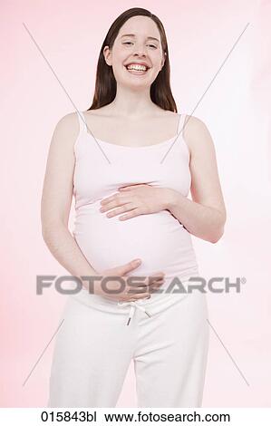 Stock Image - portrait of pregnant young woman smiling happily. Fotosearch