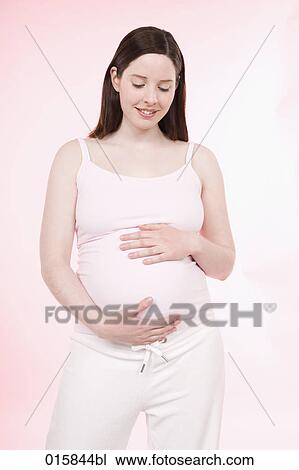 portrait of pregnant young woman caressing her belly View Large Photo Image Stock Image - portrait of pregnant young woman caressing her belly. Fotosearch
