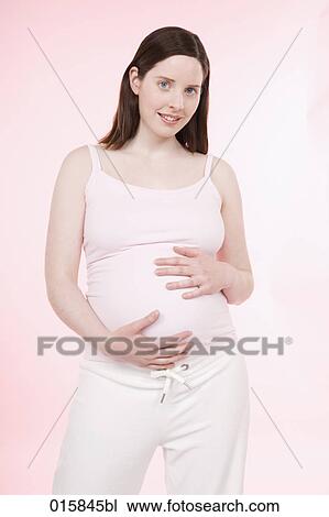 portrait of pregnant young woman looking at camera View Large Photo Image Stock Image - portrait of pregnant young woman looking at camera. Fotosearch