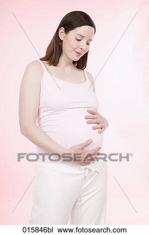 portrait of pregnant young woman caressing her belly View Large Photo Image Stock Image - portrait of pregnant young woman caressing her belly. Fotosearch