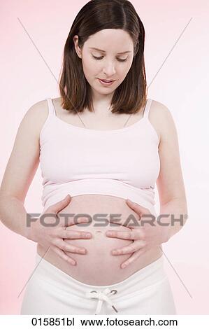 portrait of pregnant young woman caressing her belly View Large Photo Image Stock Image - portrait of pregnant young woman caressing her belly. Fotosearch