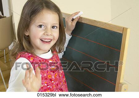 portrait of smiling girl at blackboard View Large Photo Image Stock Image - portrait of smiling girl at blackboard. Fotosearch