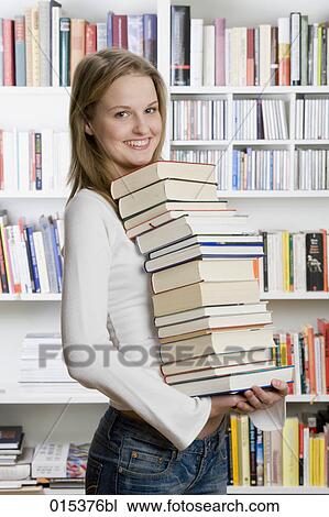 portrait of teenage girl carrying pile of books View Large Photo Image Stock Image - portrait of teenage girl carrying pile of books. Fotosearch