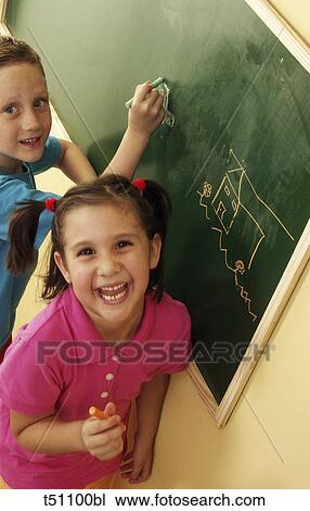 Portrait of two a boy and girl in front of blackboard View Large Photo Image Stock Image - Portrait of two a boy and girl in front of blackboard. Fotosearch
