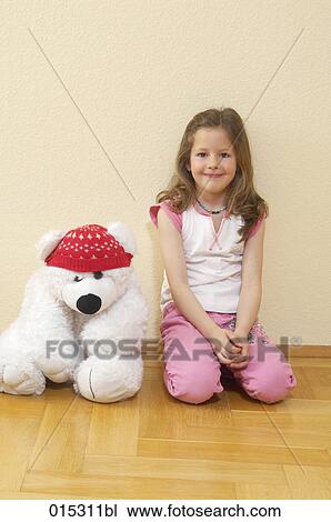 portrait of young girl kneeling on floor with cuddly toy in shape of polar bear View Large Photo Image Stock Image - portrait of young girl kneeling on floor with cuddly toy in shape of polar bear. Fotosearch