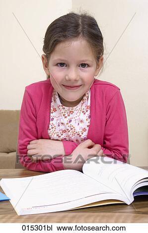 portrait of young girl with book on table View Large Photo Image Stock Image - portrait of young girl with book on table. Fotosearch
