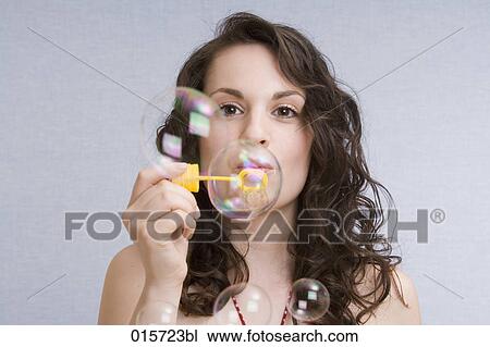 portrait of young woman blowing soap bubbles View Large Photo Image Stock Image - portrait of young woman blowing soap bubbles. Fotosearch
