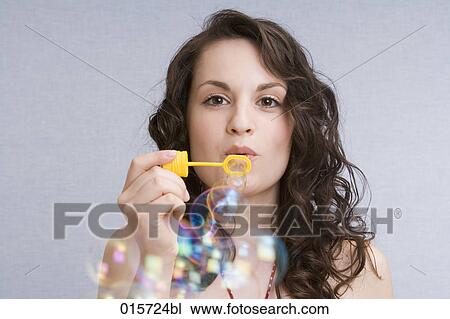 portrait of young woman blowing soap bubbles View Large Photo Image Stock Image - portrait of young woman blowing soap bubbles. Fotosearch