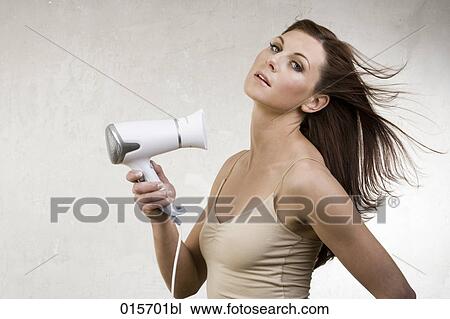 portrait of young woman drying her long hair View Large Photo Image Stock Image - portrait of young woman drying her long hair. Fotosearch