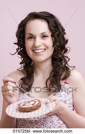 portrait of young woman enjoying piece of cake View Large Photo Image Stock Image - portrait of young woman enjoying piece of cake. Fotosearch