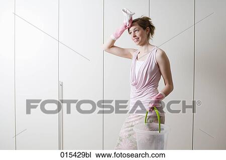portrait of young woman exhausted from housecleaning View Large Photo Image Stock Image - portrait of young woman exhausted from housecleaning. Fotosearch