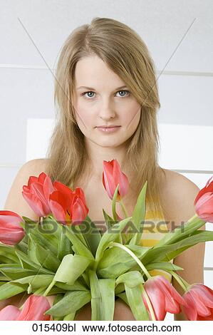 portrait of young woman holding bunch of red tulips View Large Photo Image Stock Image - portrait of young woman holding bunch of red tulips. Fotosearch