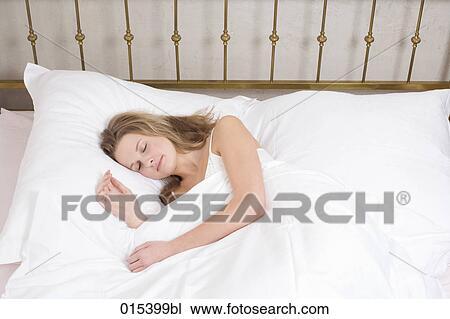 portrait of young woman sleeping in bed View Large Photo Image Stock Image - portrait of young woman sleeping in bed. Fotosearch
