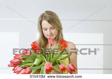portrait of young woman smelling red tulips View Large Photo Image Stock Image - portrait of young woman smelling red tulips. Fotosearch