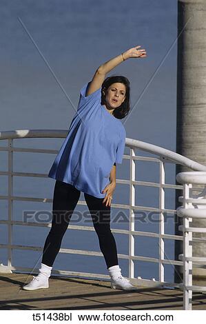 Pregnant woman exercising outdoors View Large Photo Image Stock Image - Pregnant woman exercising outdoors. Fotosearch