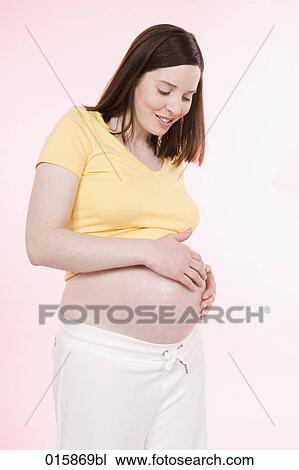 pregnant young woman applying lotion on her belly to avoid stretch marks View Large Photo Image Stock Image - pregnant young woman applying lotion on her belly to avoid stretch marks. Fotosearch